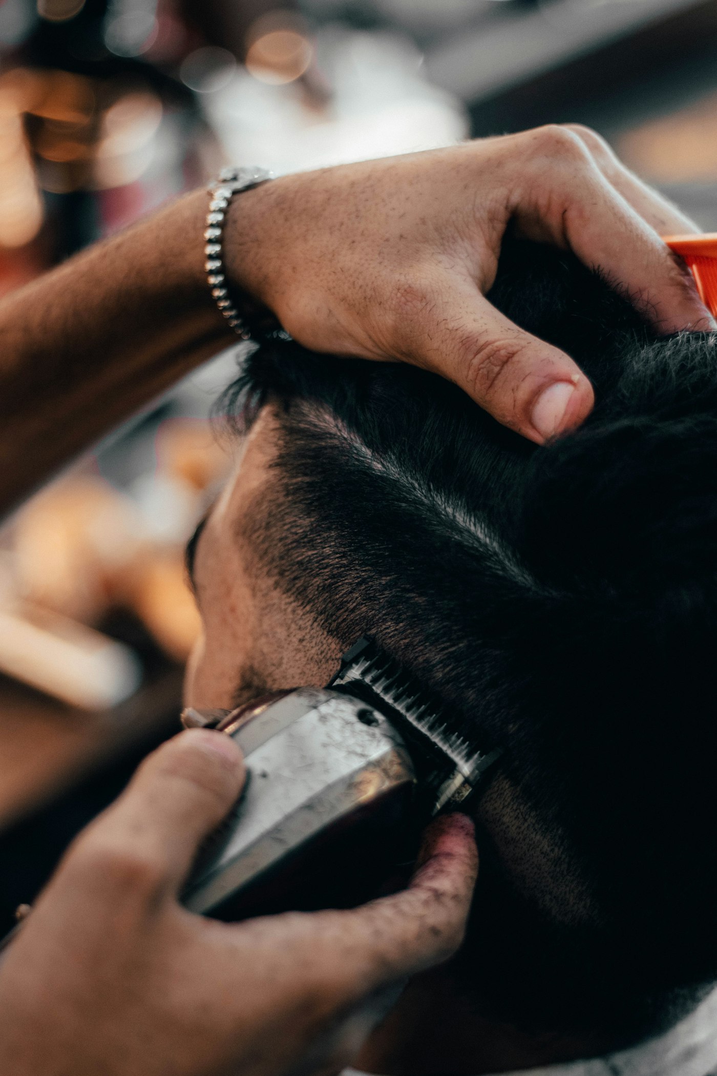 Close-up of a barber fading hair with clippers