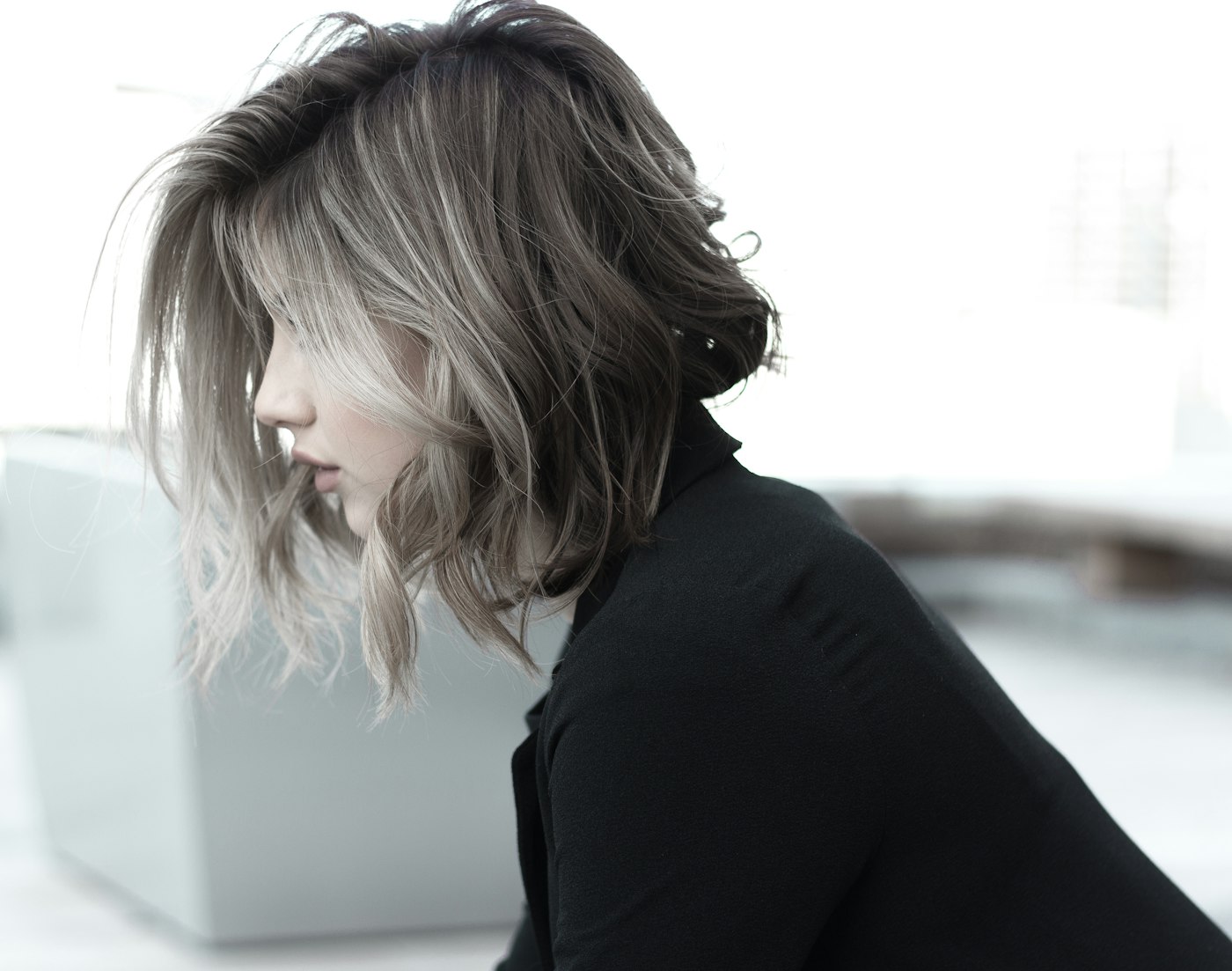 Smooth, glossy shoulder-length hair after a smoothening treatment